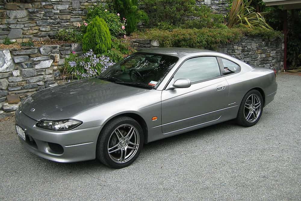 Silver Nissan Silvia coupe parked outdoors, a popular Japanese performance car imported from Japan.